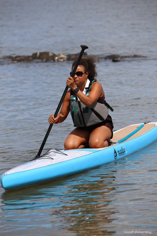a woman is sitting on a surfboard in the water