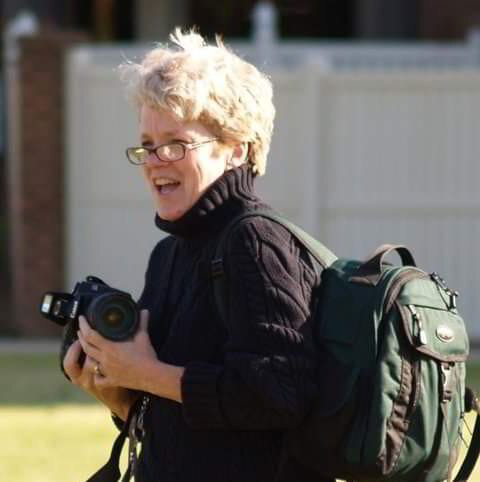 a woman with a camera in her backpack