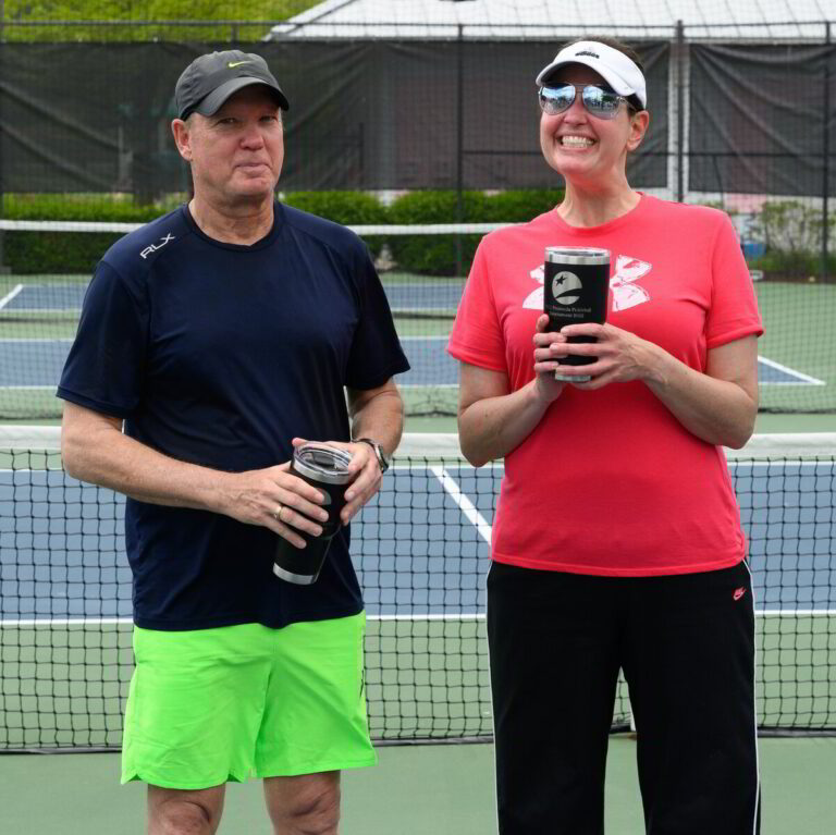 a man and woman standing on a tennis court