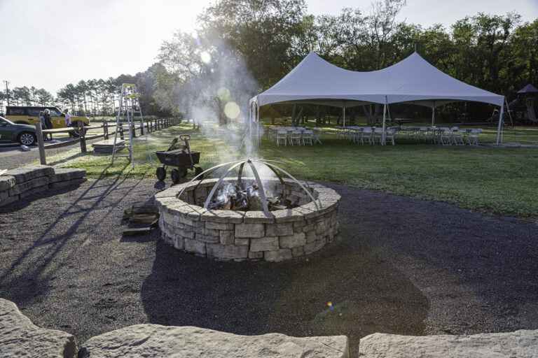 an outdoor fire pit surrounded by large rocks