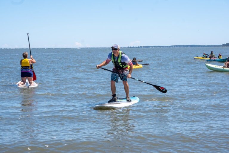a man on a paddle board in the water