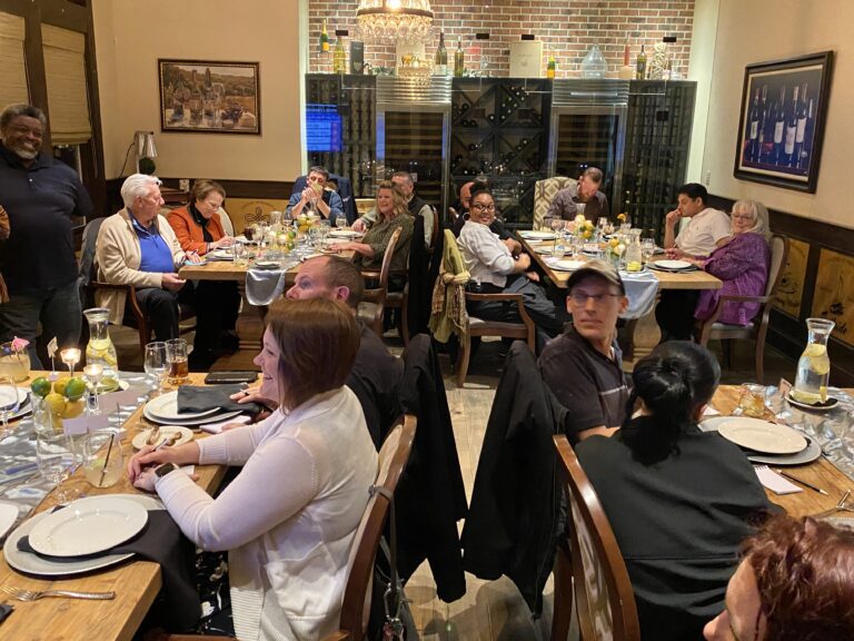 a group of people sitting around a table eating food