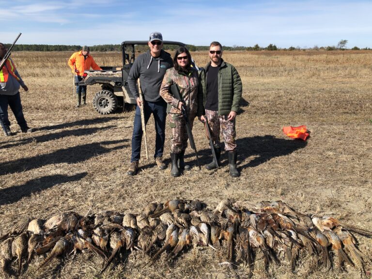 a group of people standing next to a pile of dead birds