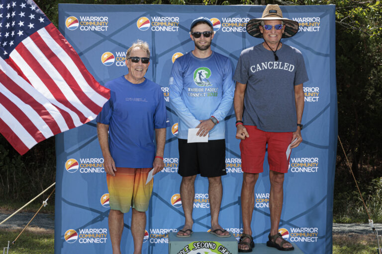 three men standing on a podium with an american flag