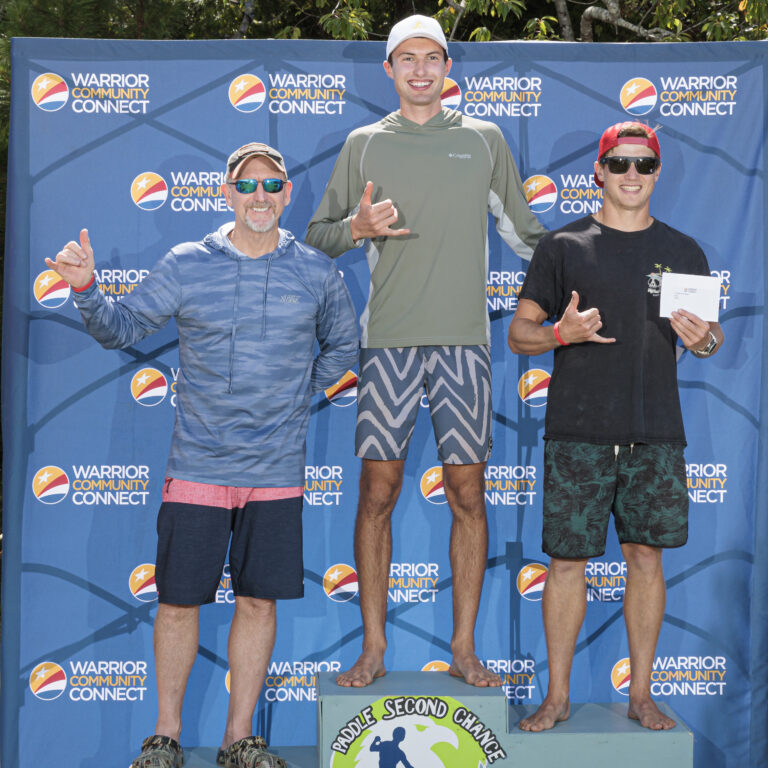 three men standing on top of a podium