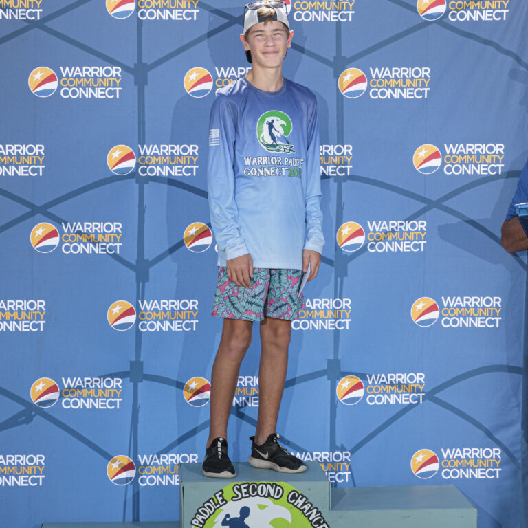 a young boy standing on top of a podium
