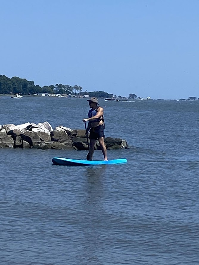 a man is standing on a surfboard in the water