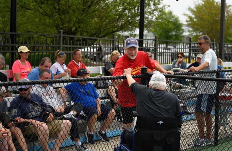 a group of people sitting in bleachers watching something