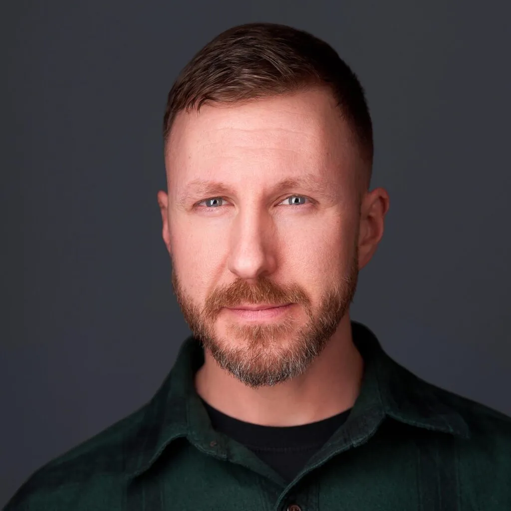 a man with a beard and green shirt