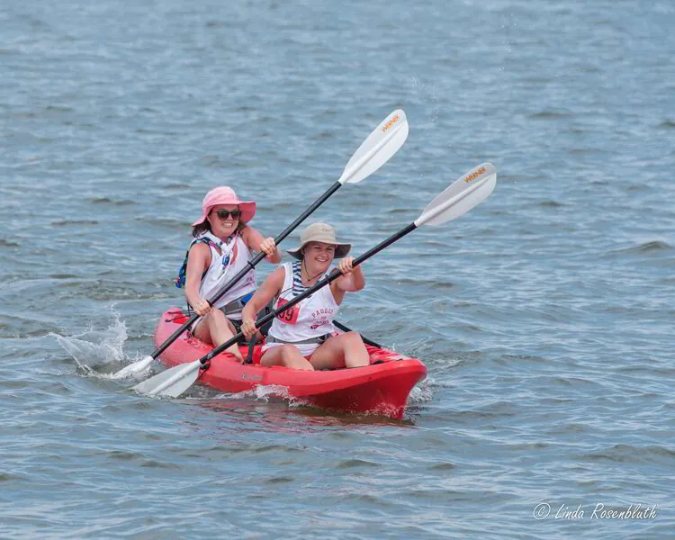 two people in a red kayak on the water