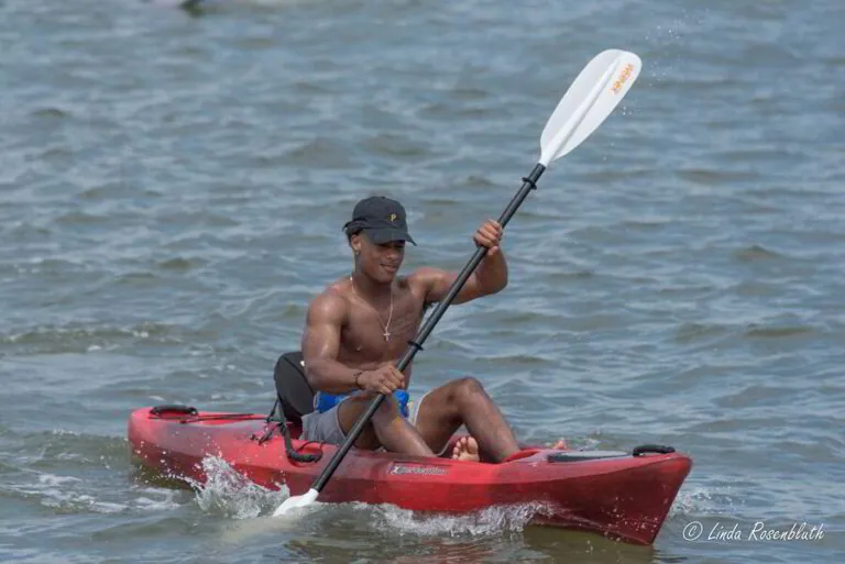 a man is paddling his kayak in the water