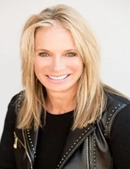 a woman with blonde hair wearing a leather jacket
