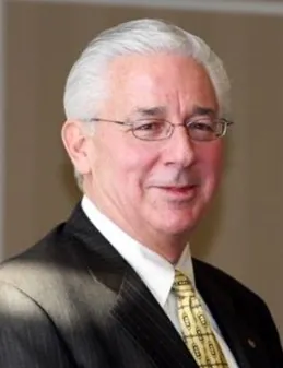 an older man wearing a suit and tie