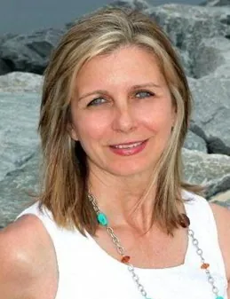 a woman standing in front of some rocks