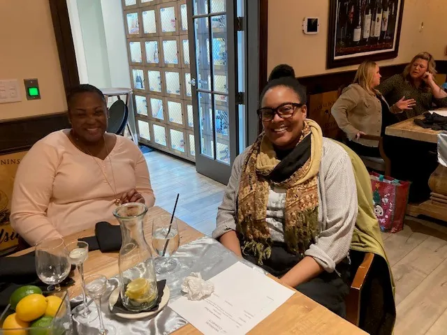 two women sitting at a table in a restaurant